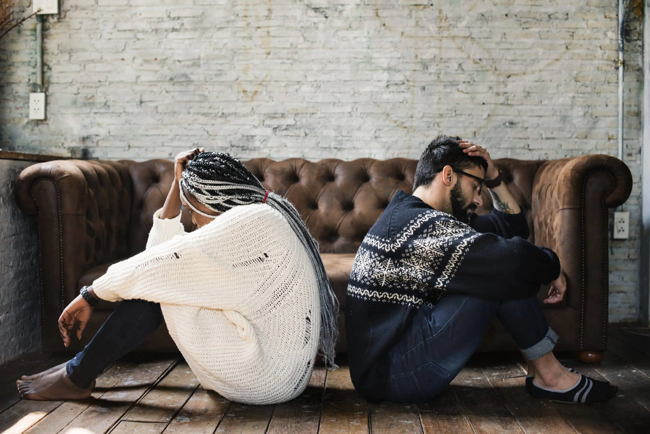 a man and woman sitting on a couch