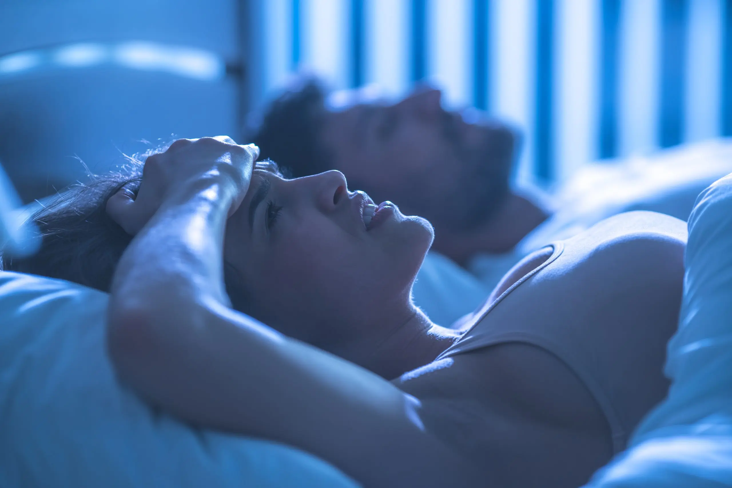 a man and woman lying in bed