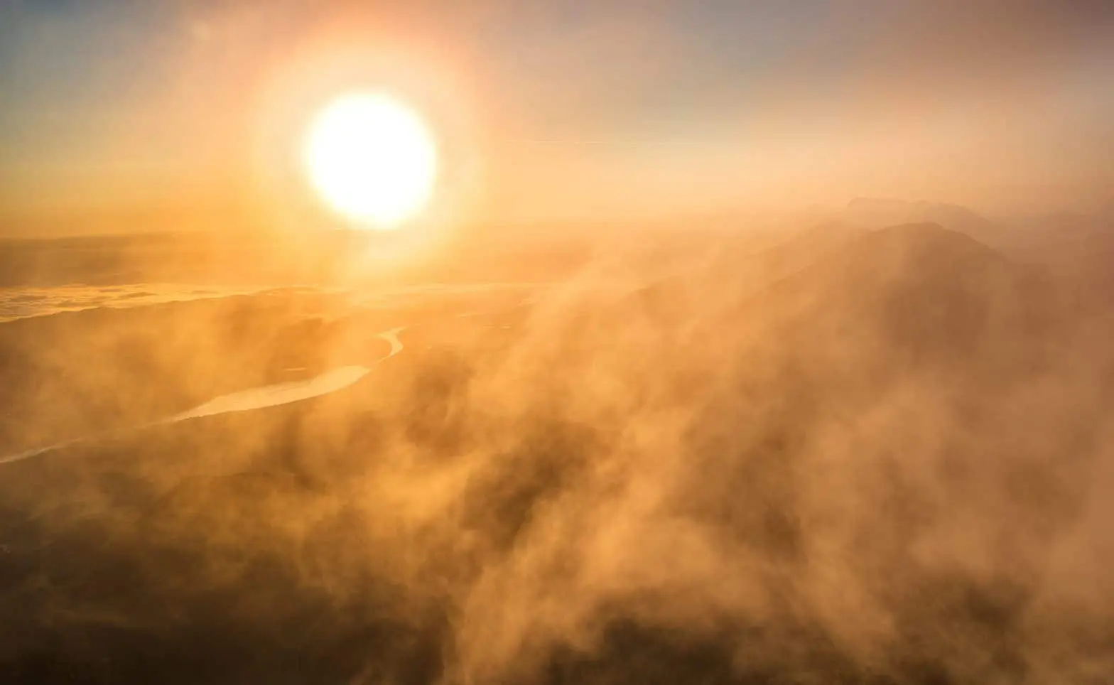 a sun over a valley