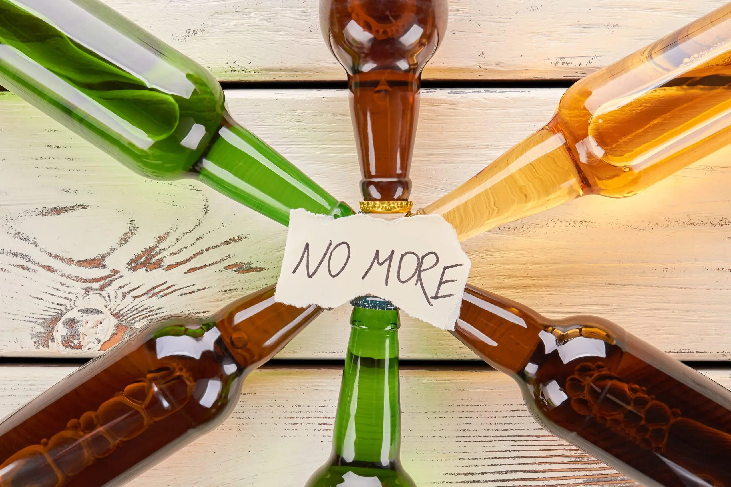 a group of bottles with a sign around them