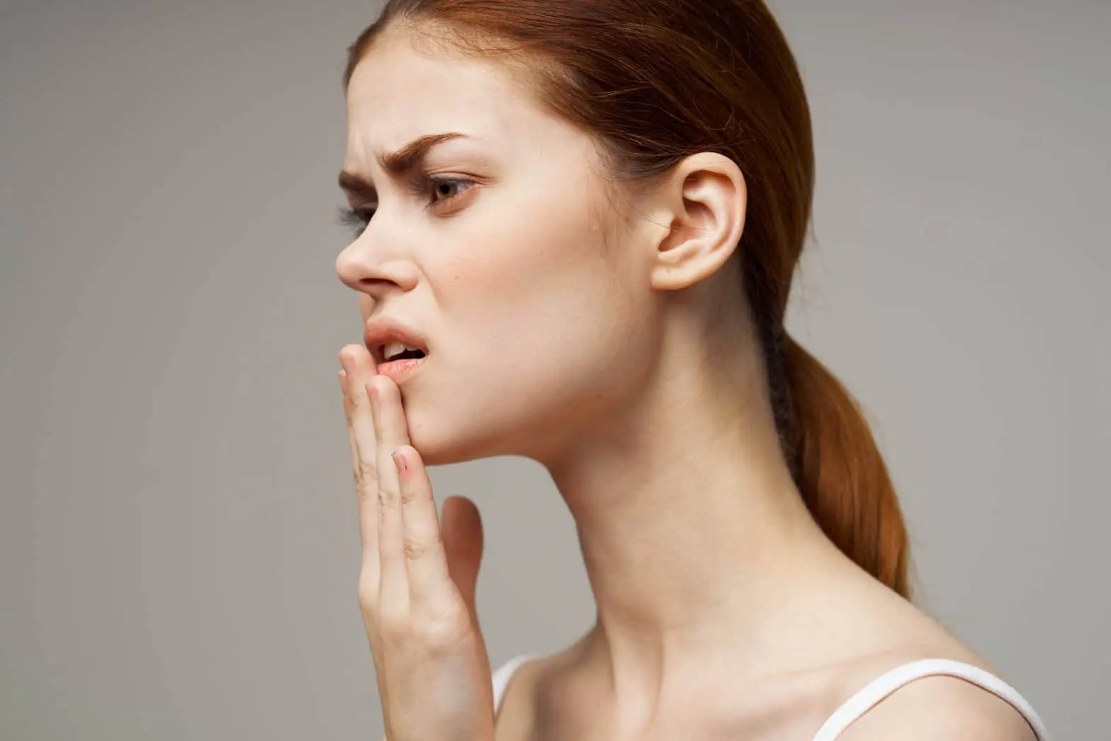 a woman with her hand on her mouth