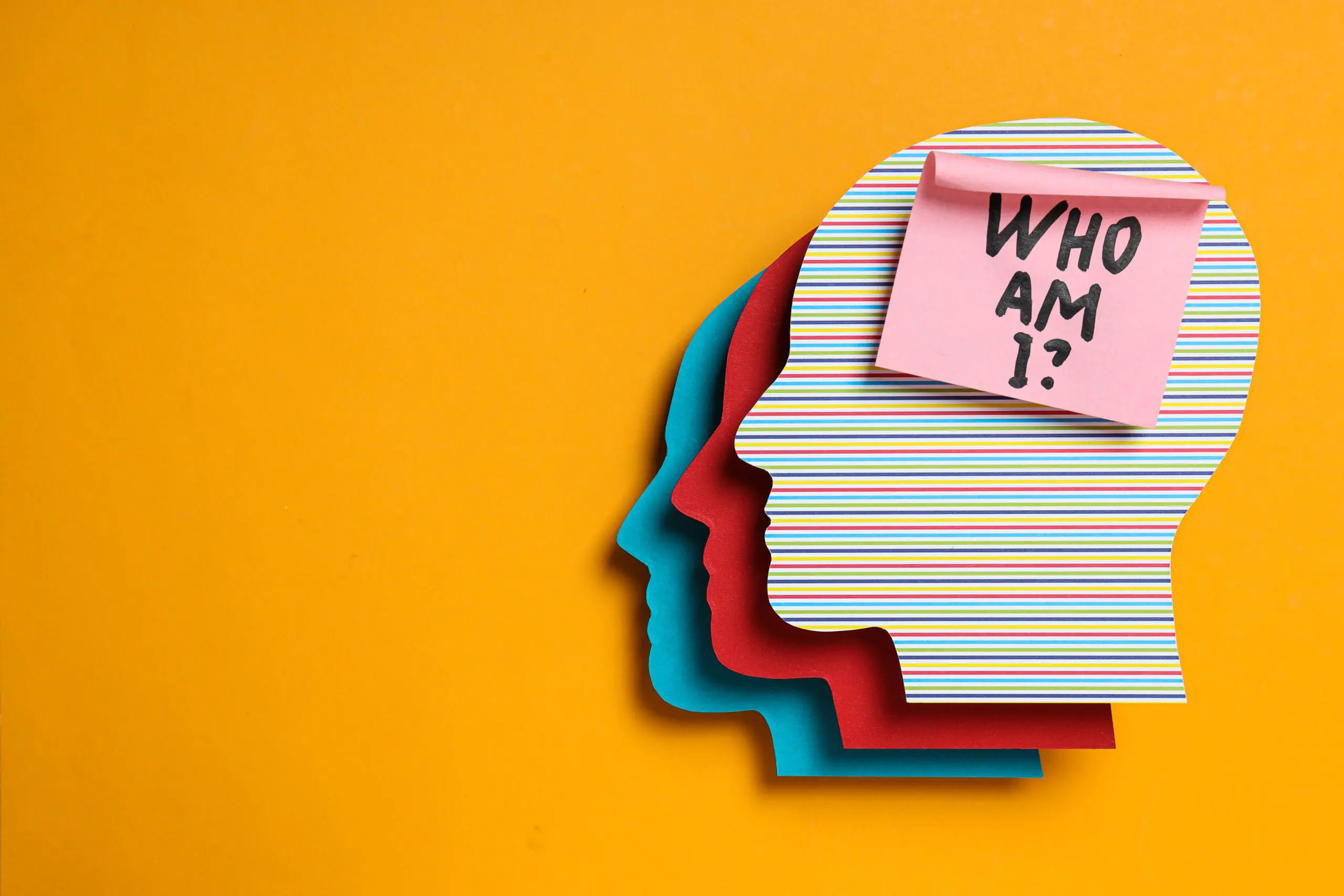 a group of colorful paper cut out of heads