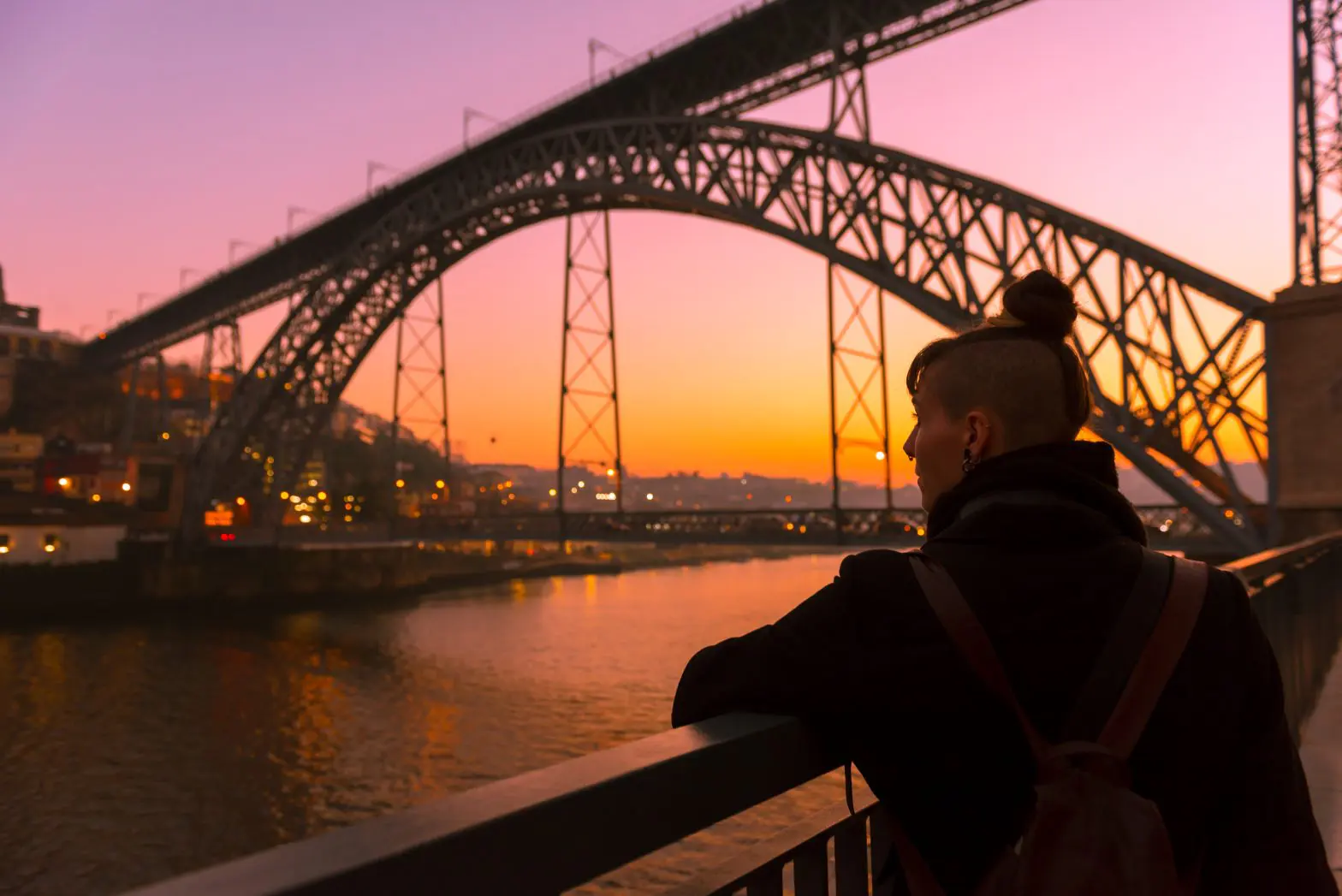 a woman looking at a bridge