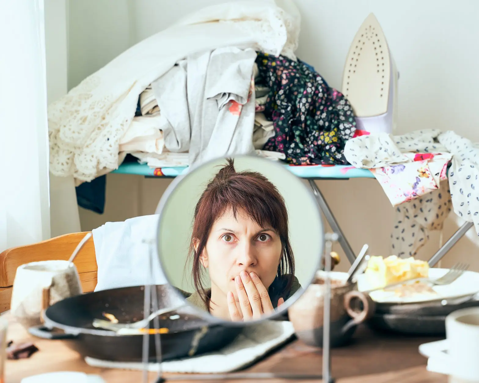 a woman looking at her face in a mirror