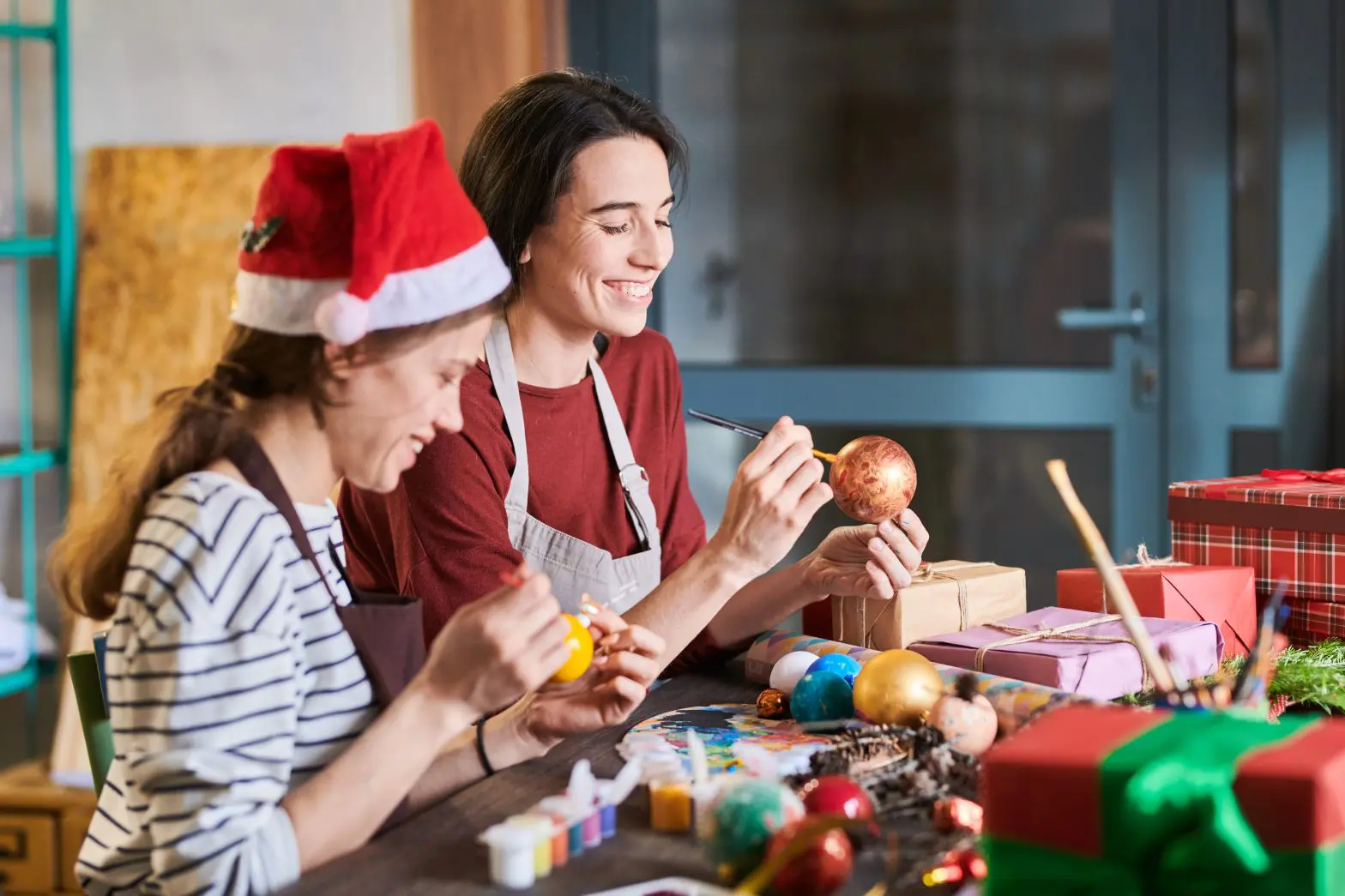 a group of women painting ornaments