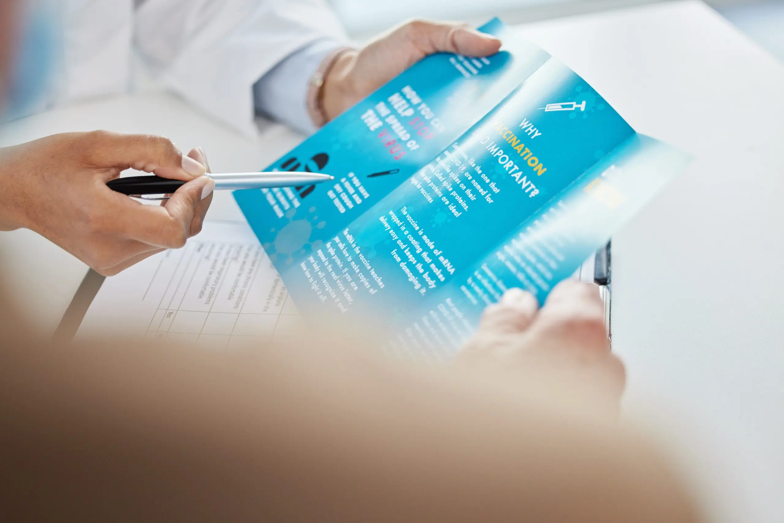 hand picking up recovery support group pamphlet from table