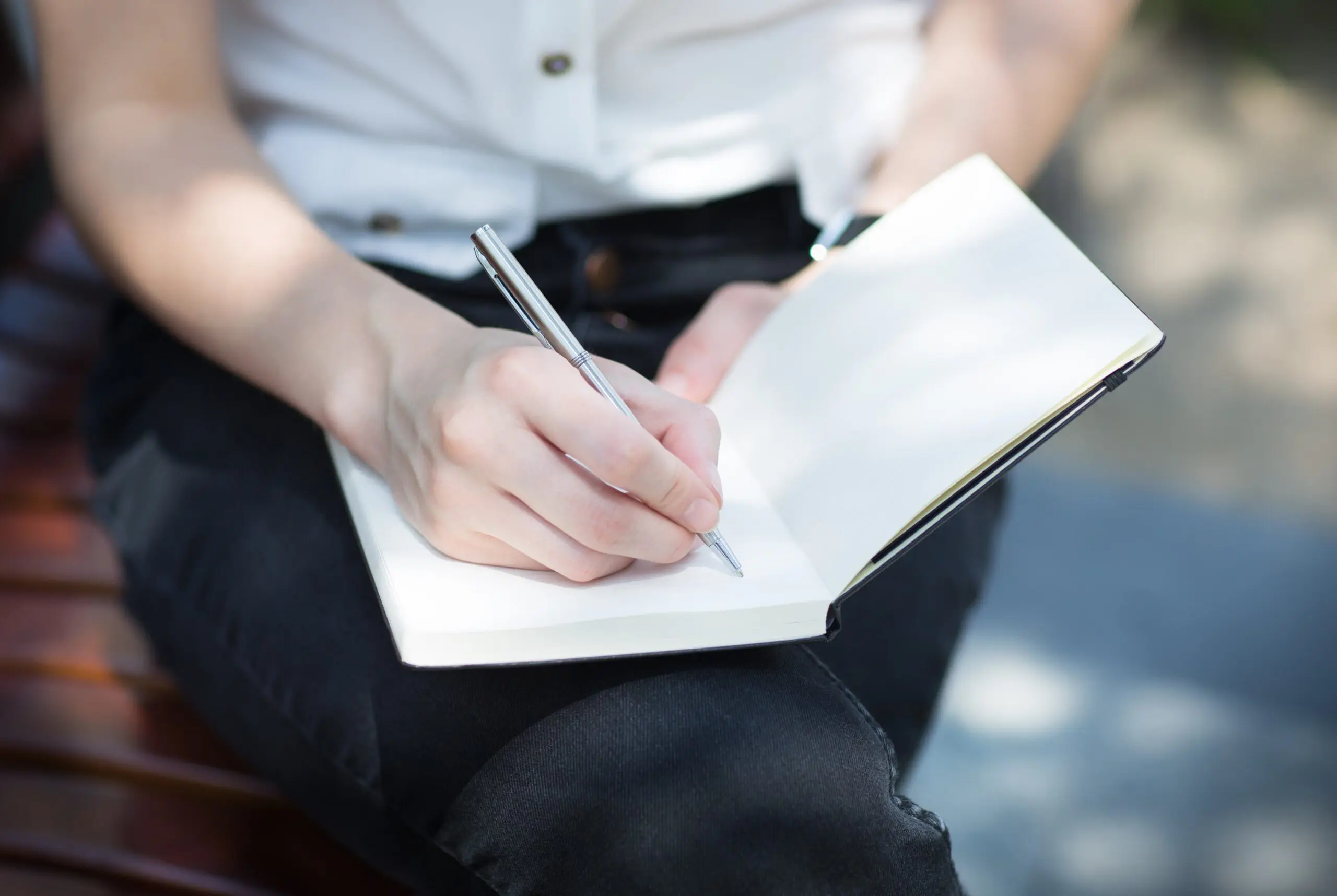 student writing in planner to stay organized and reduce stress