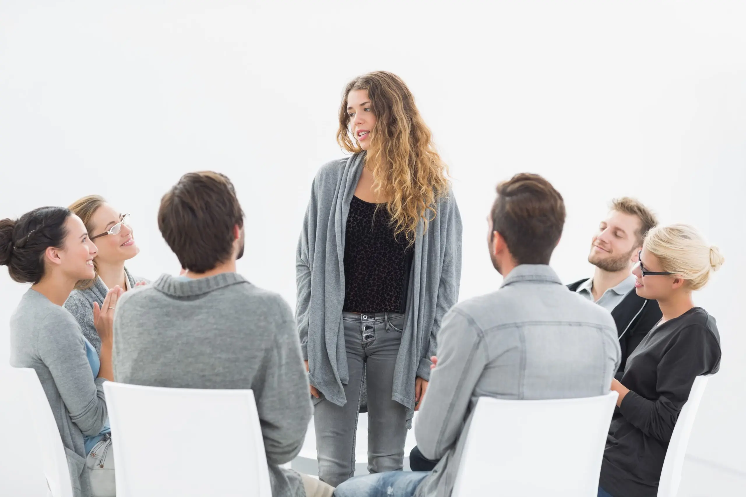 group therapy session with counselor and participants seated in a circle