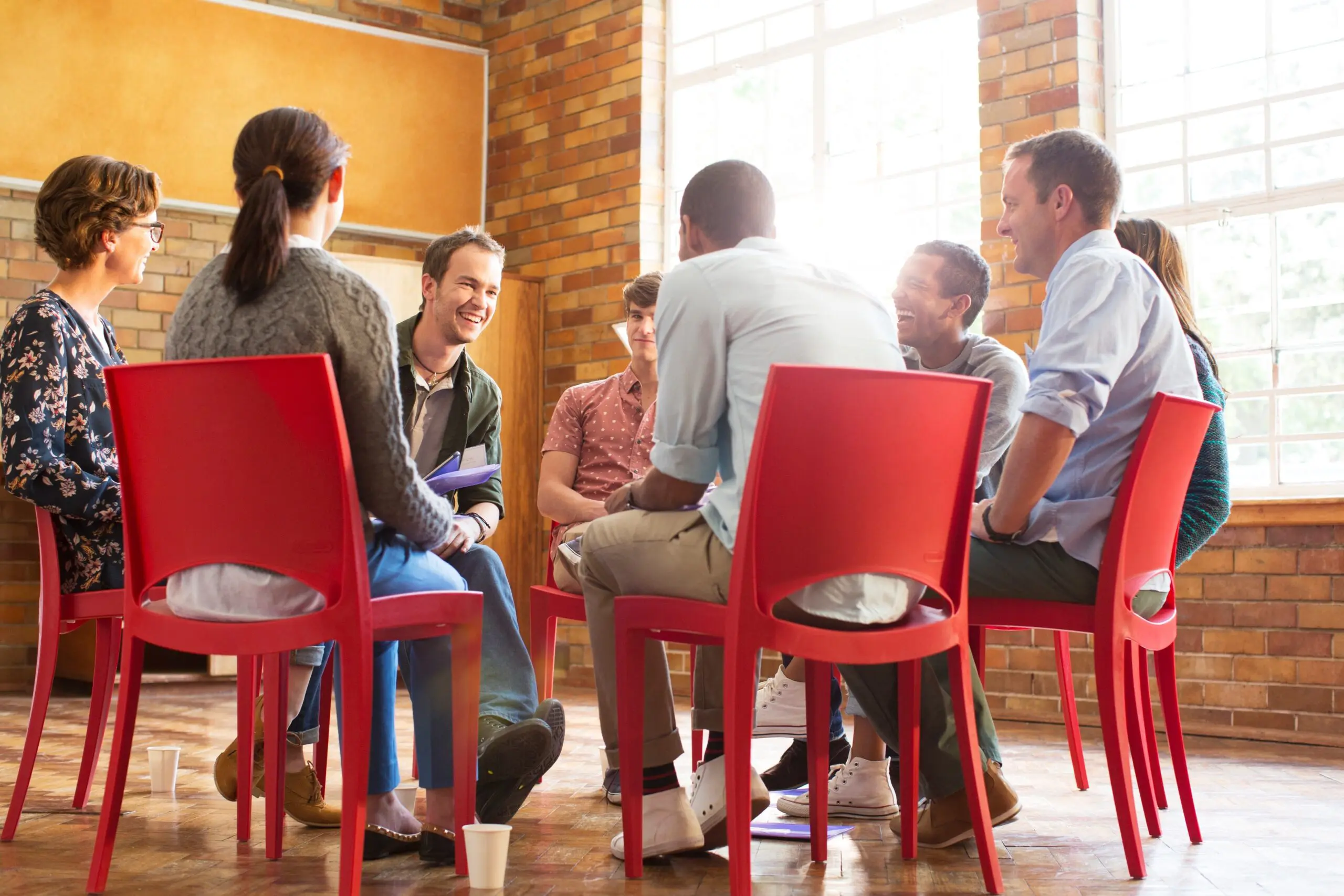 people sharing and supporting each other in recovery group therapy