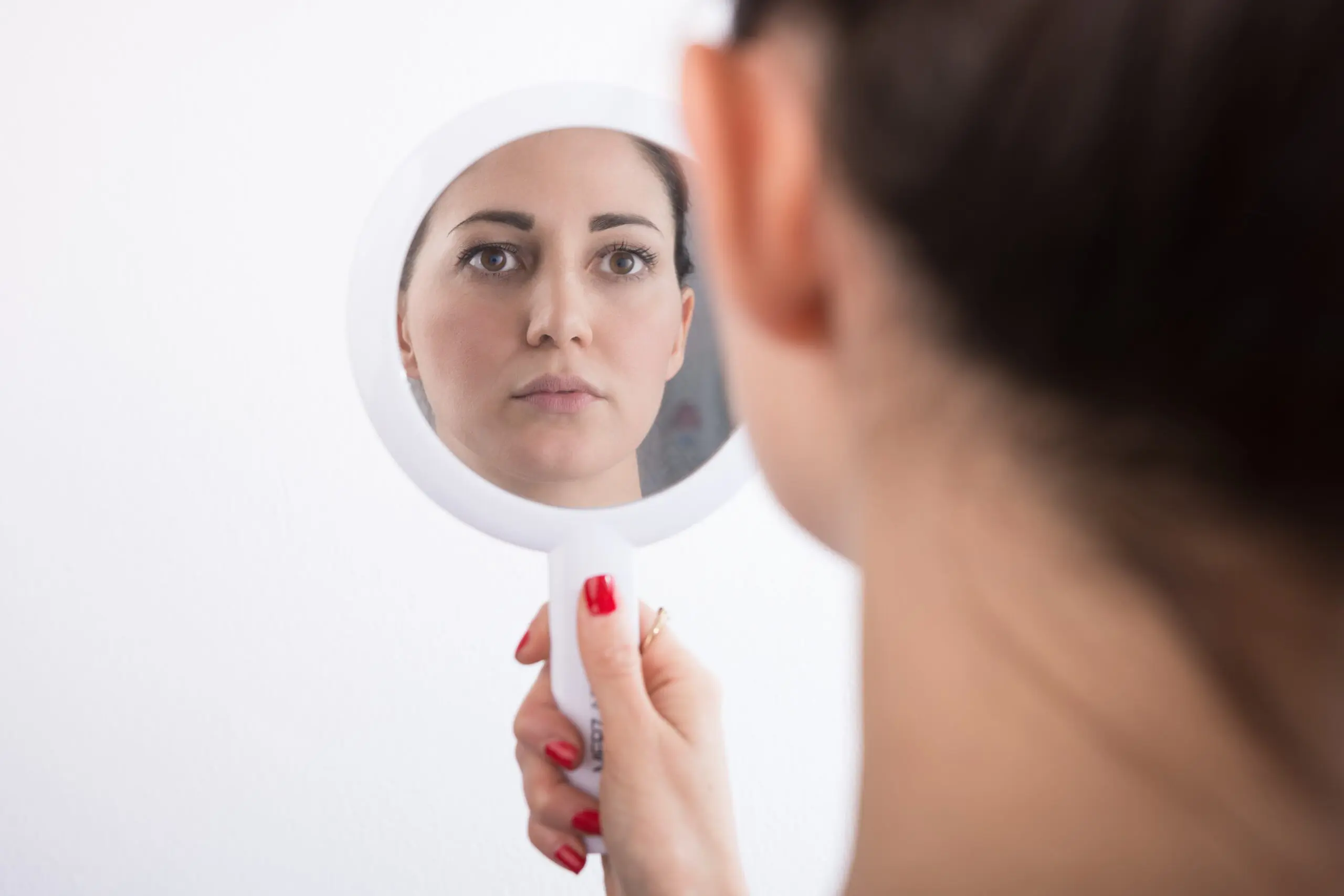person reflecting in the mirror, symbolizing self-awareness and personal struggle