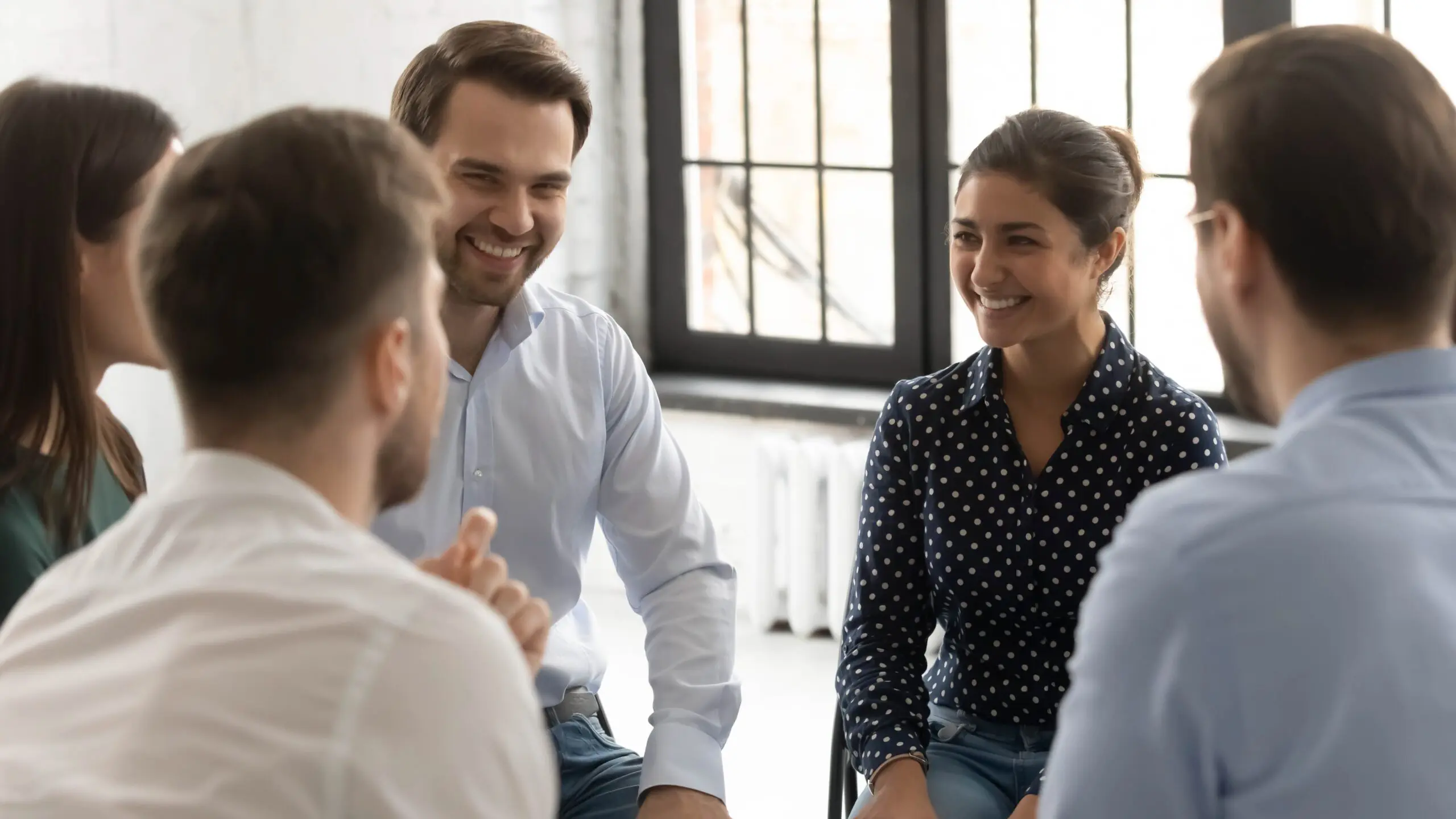 Group therapy session with people smiling and engaging in discussion scaled Why Step 5 Is a Turning Point in the 12-Step Program