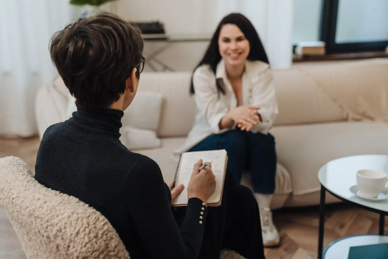 Individual discussing Step 5 of the 12-Step Program with a counselor in a safe setting