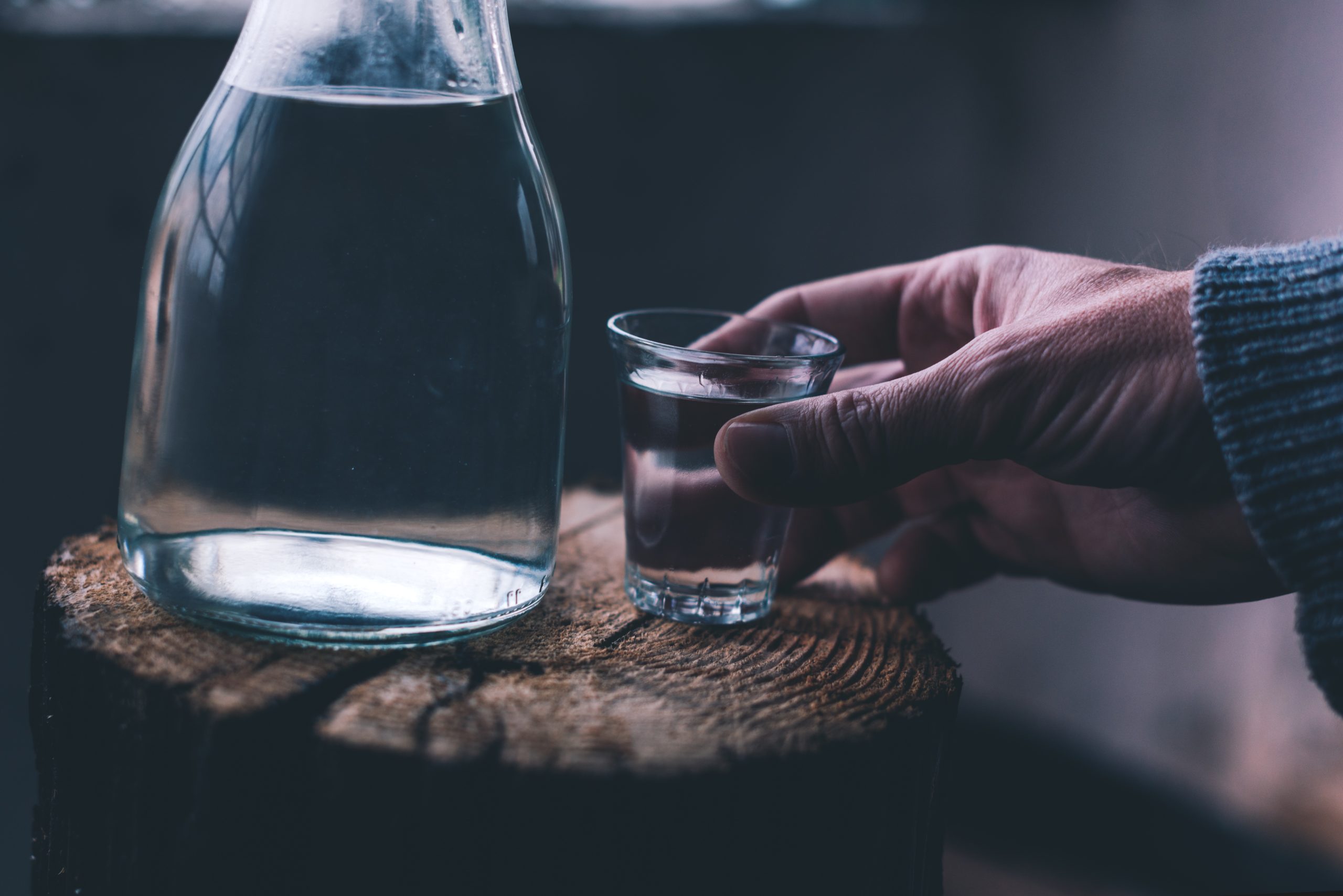a hand holding a shot glass