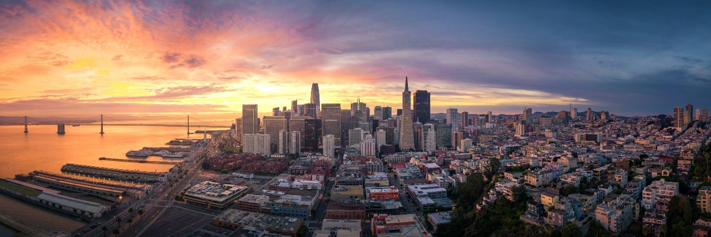 a city skyline with a sunset
