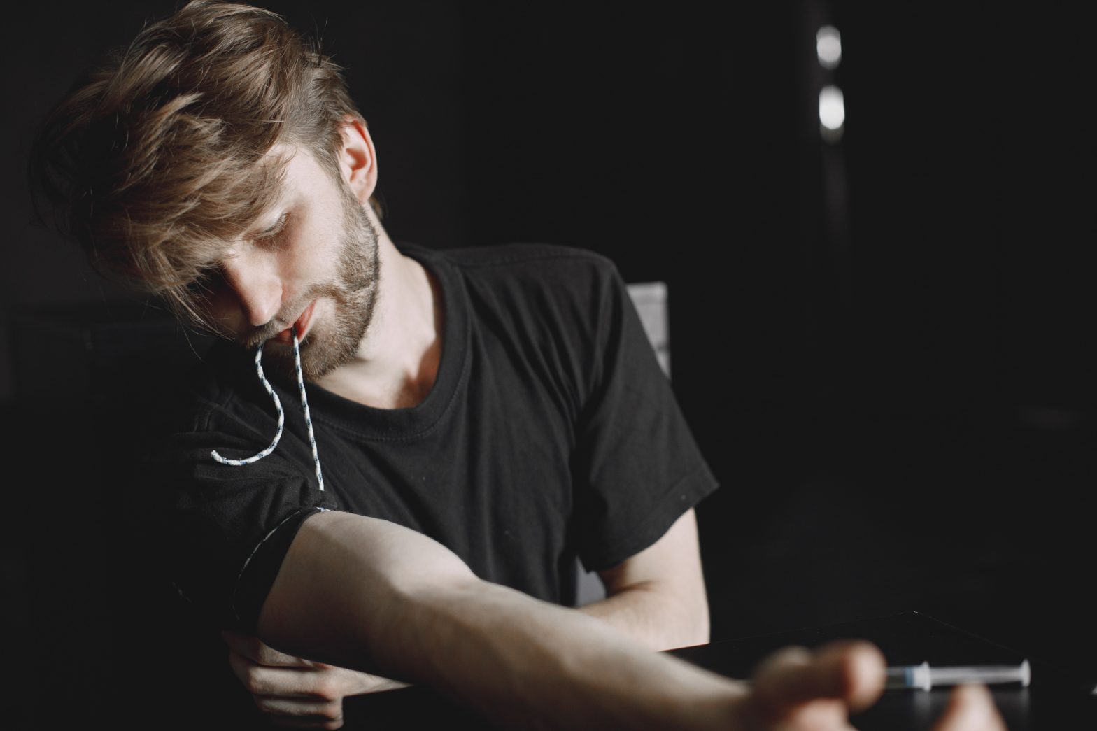 a man with a beard and mustache sitting at a table