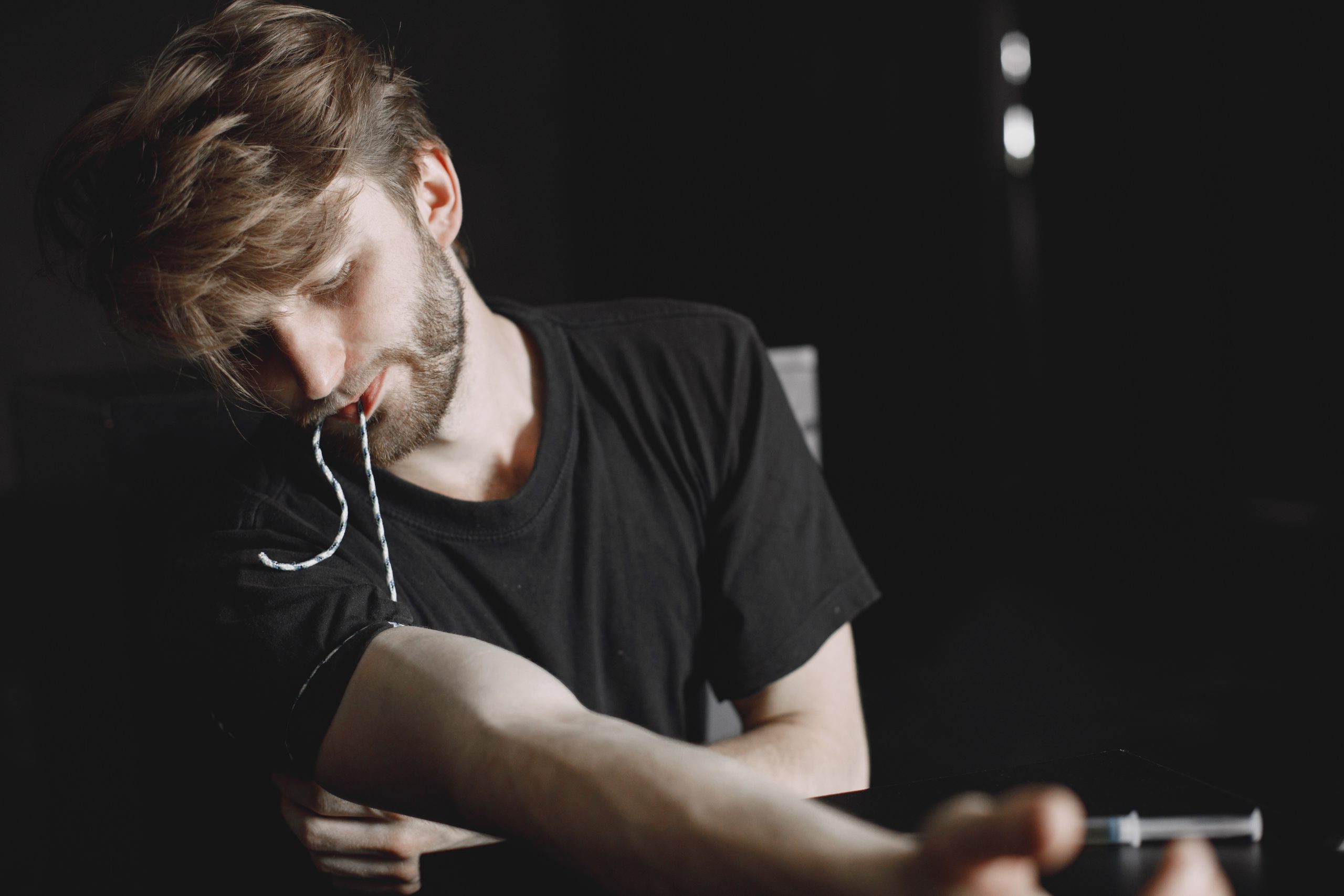 a man with a beard and mustache sitting at a table