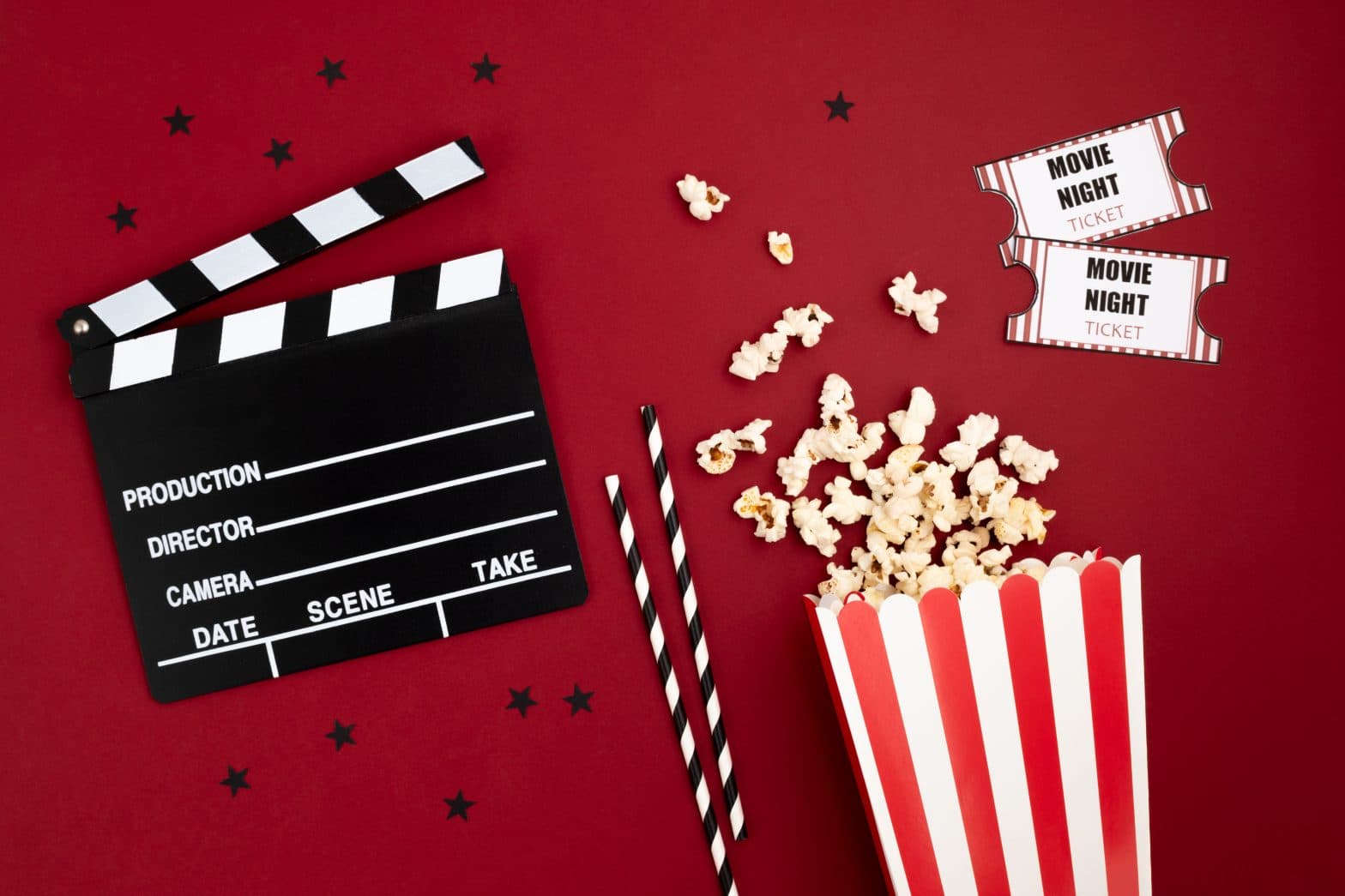 a movie clapper board and popcorn