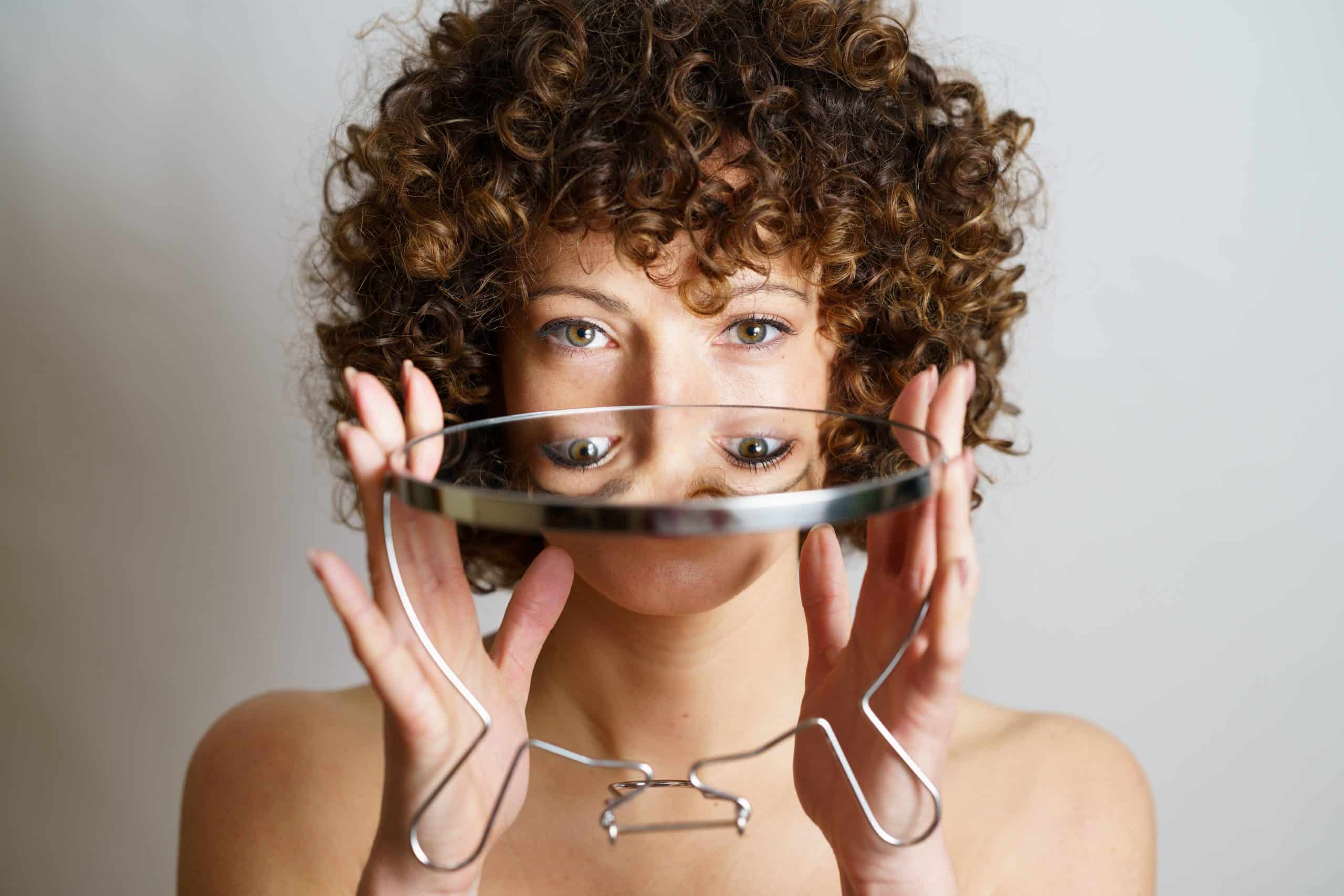 a woman holding a mirror