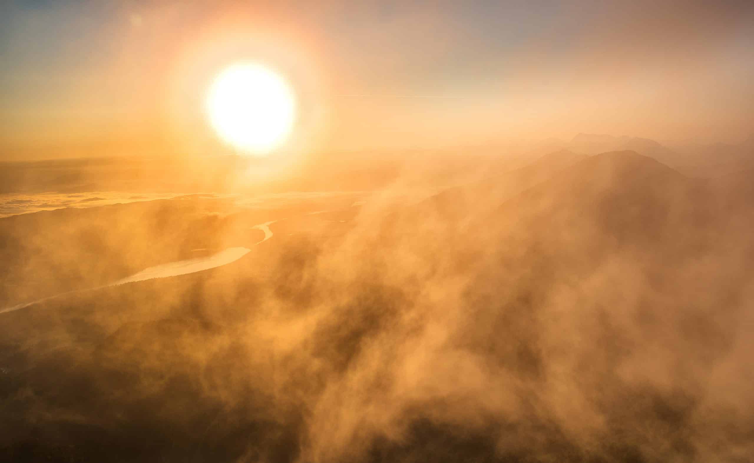 a sun over a valley