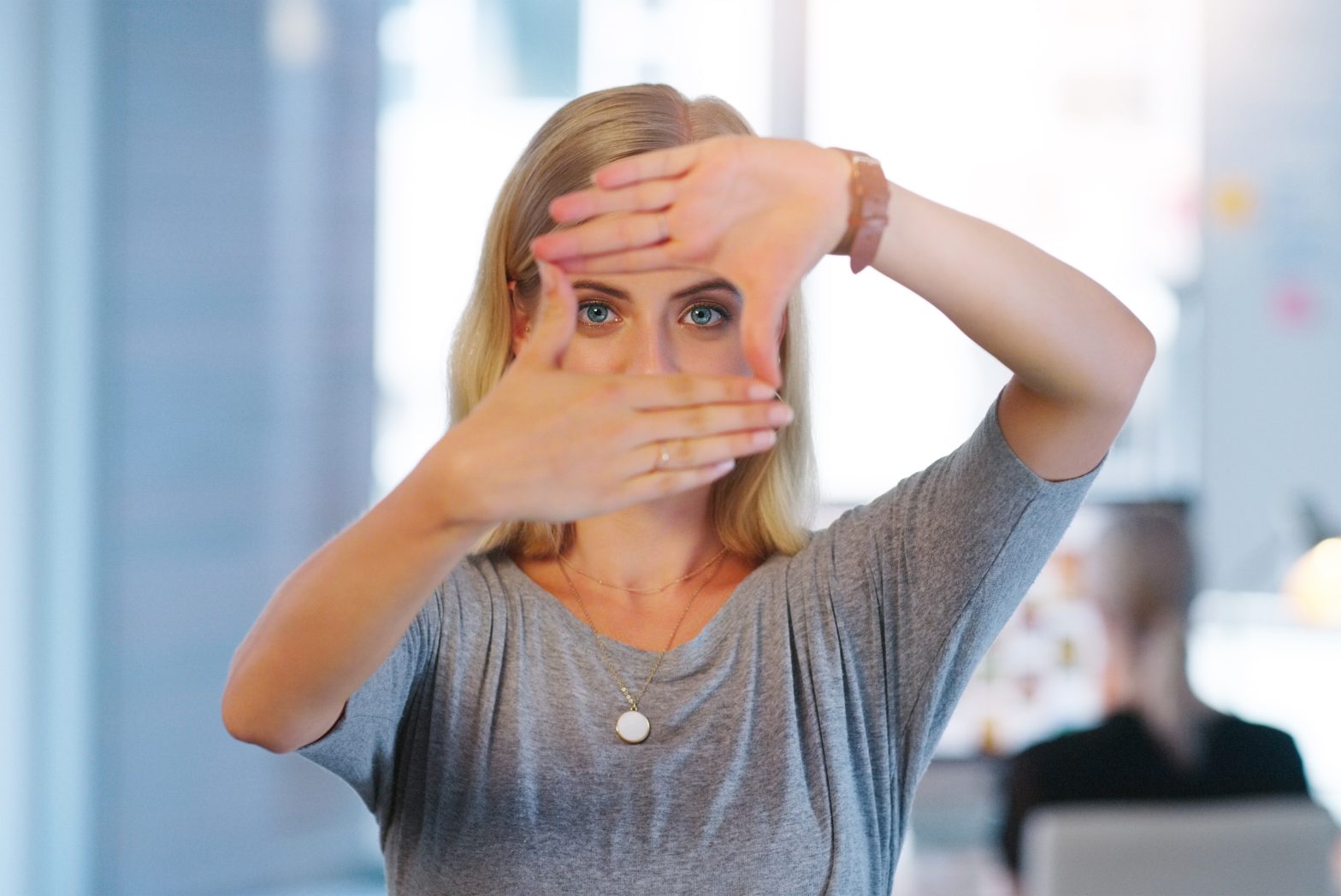 a woman holding her hands over her face