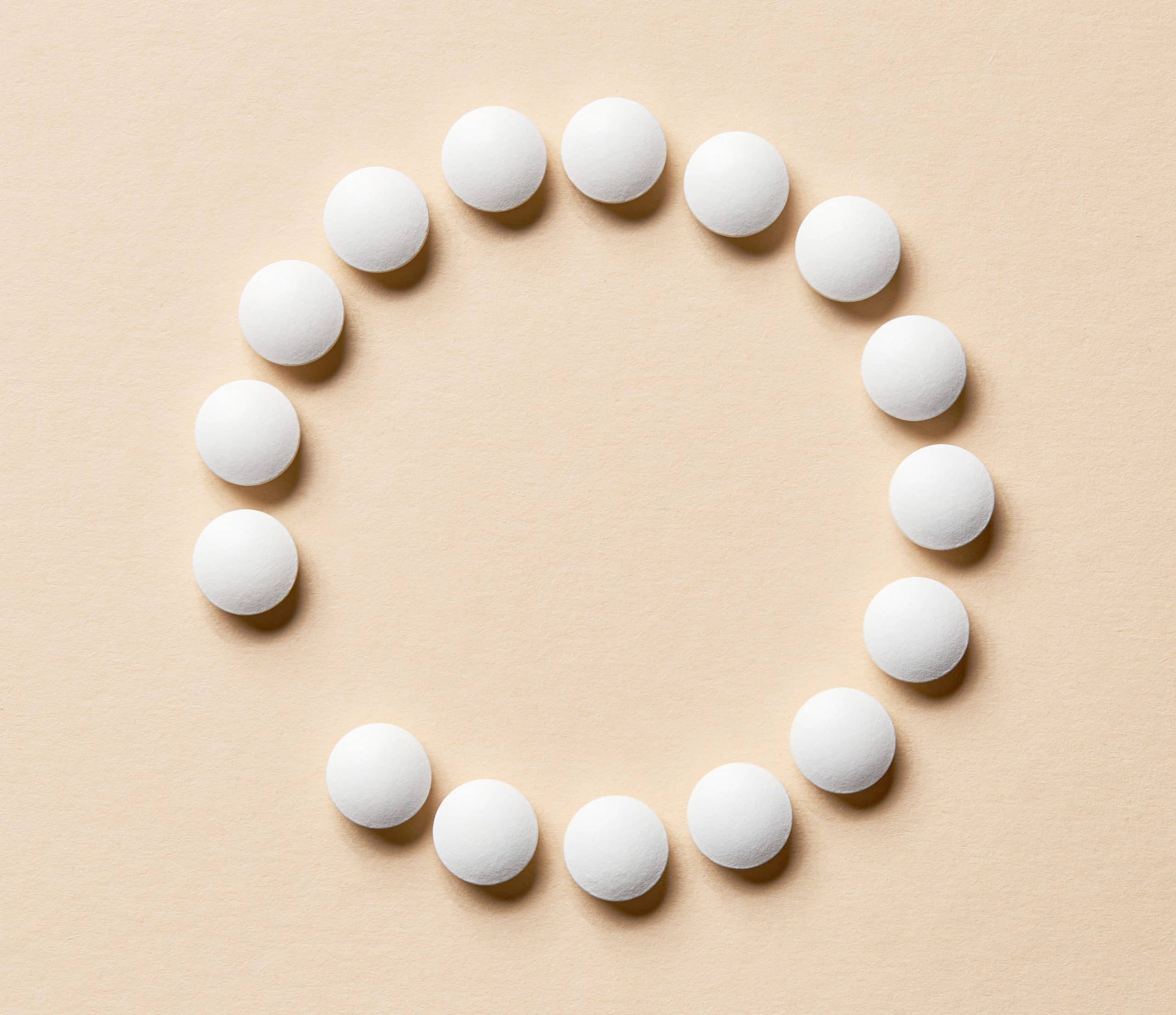 a group of white pills arranged in a circle