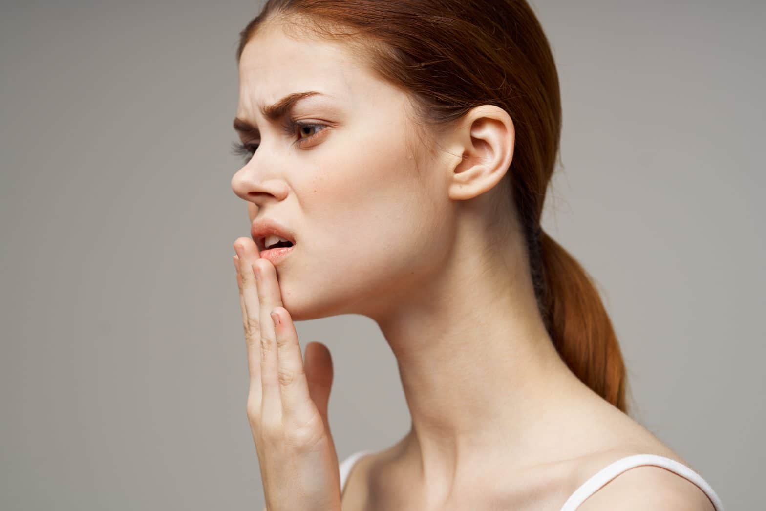 a woman with her hand on her mouth