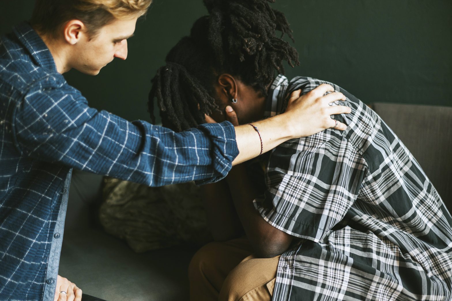 a man touching a woman's shoulder