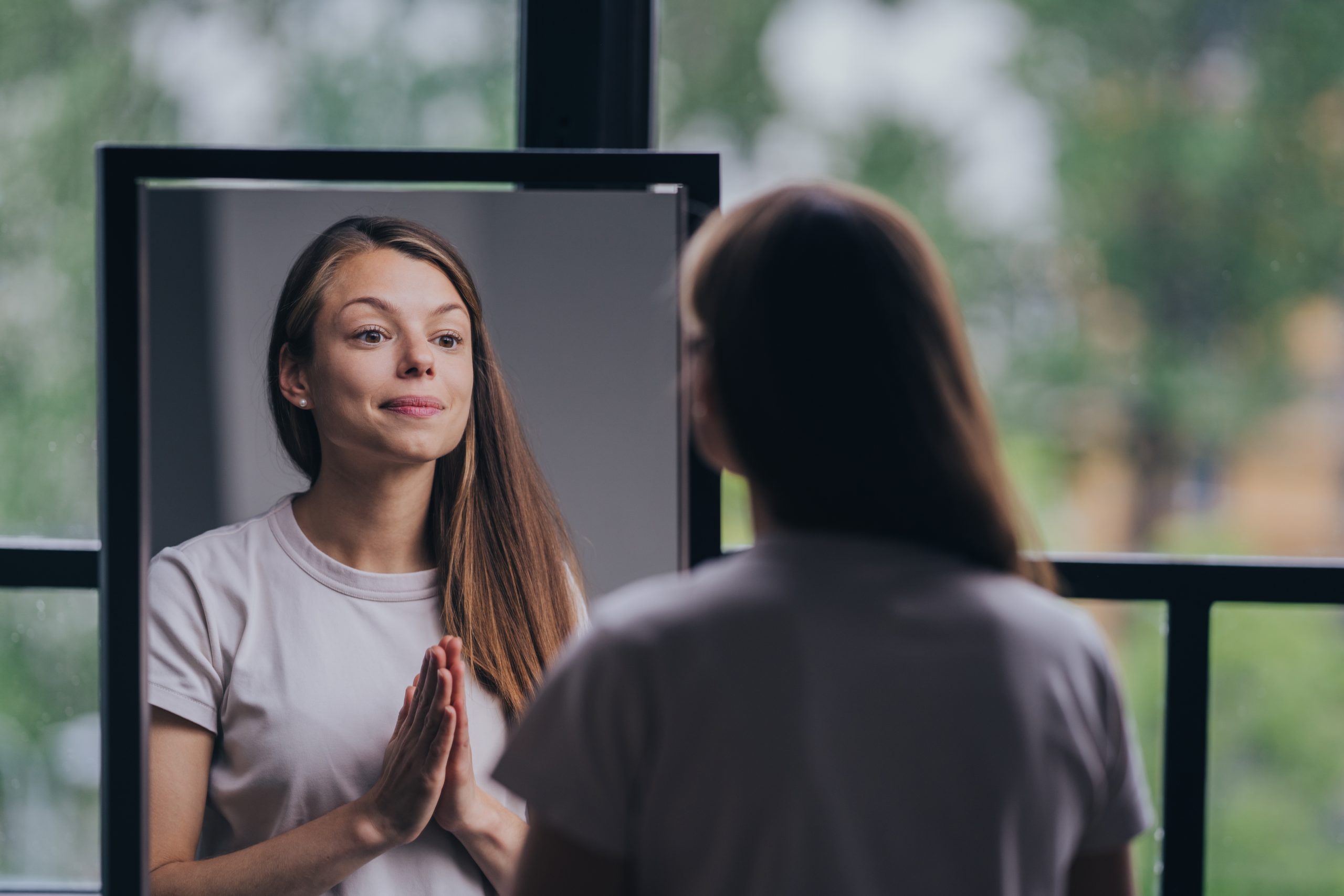 a woman looking at herself in a mirror