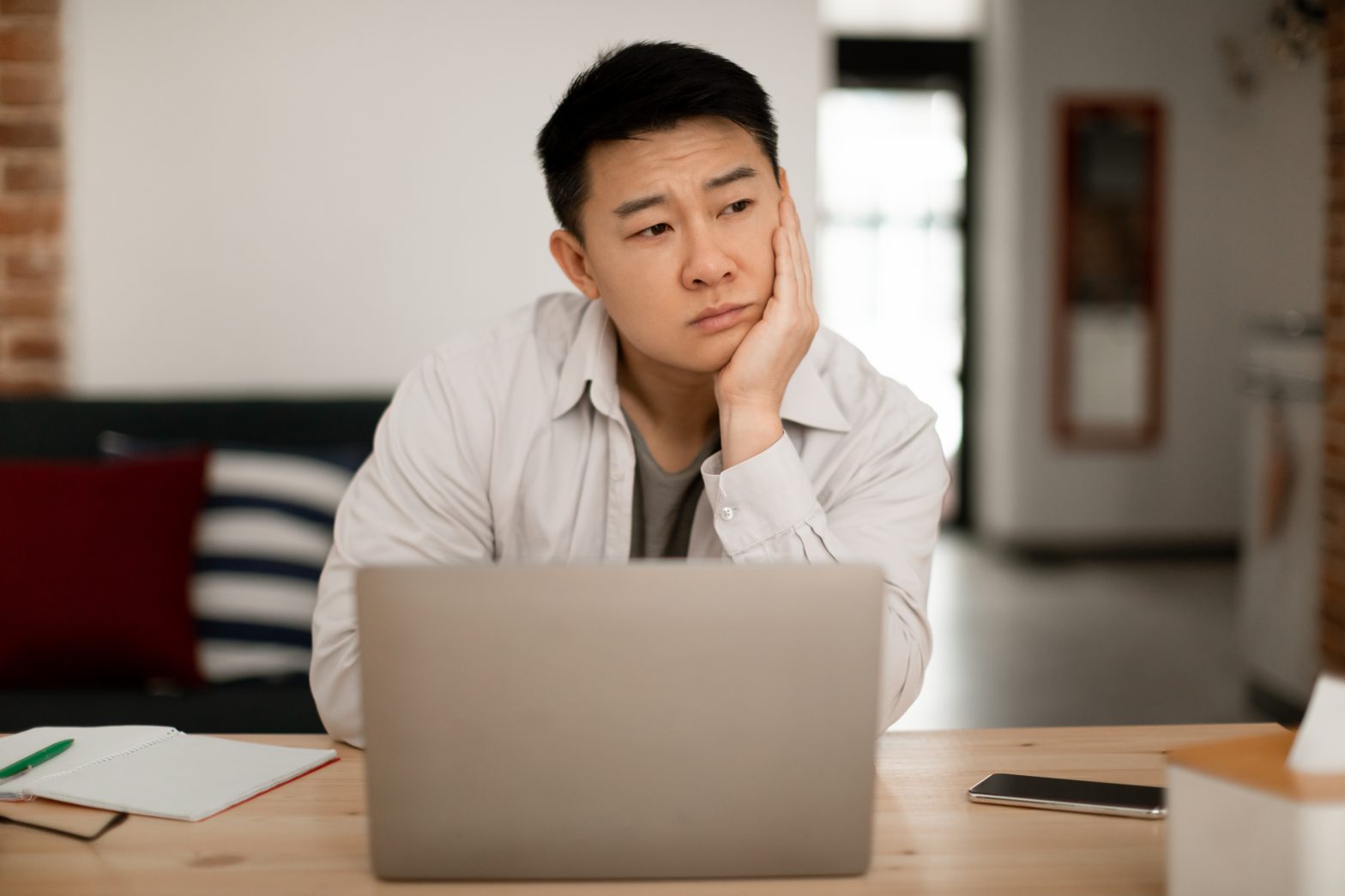a man sitting at a table with a laptop