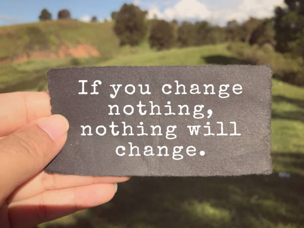 a hand holding a piece of paper with white text