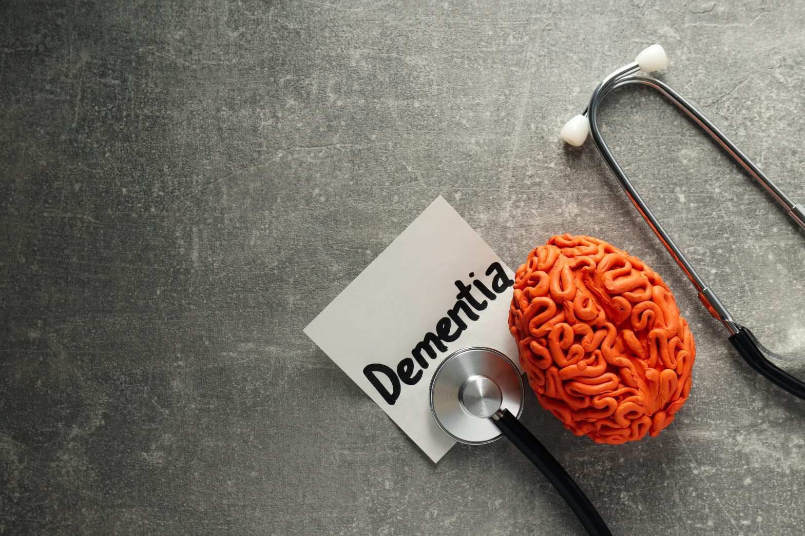 a brain with a stethoscope and a note