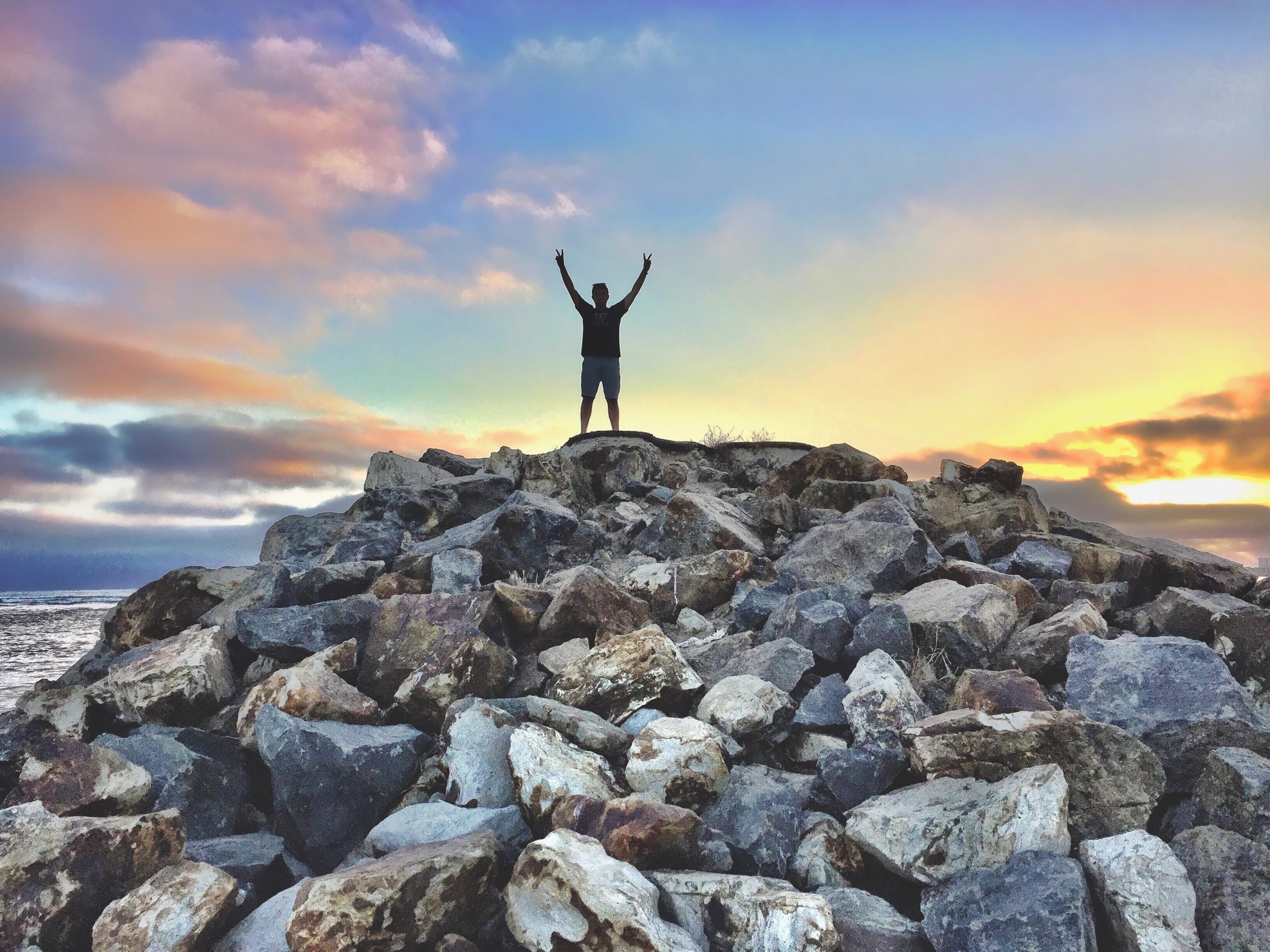 a man standing on a pile of rocks