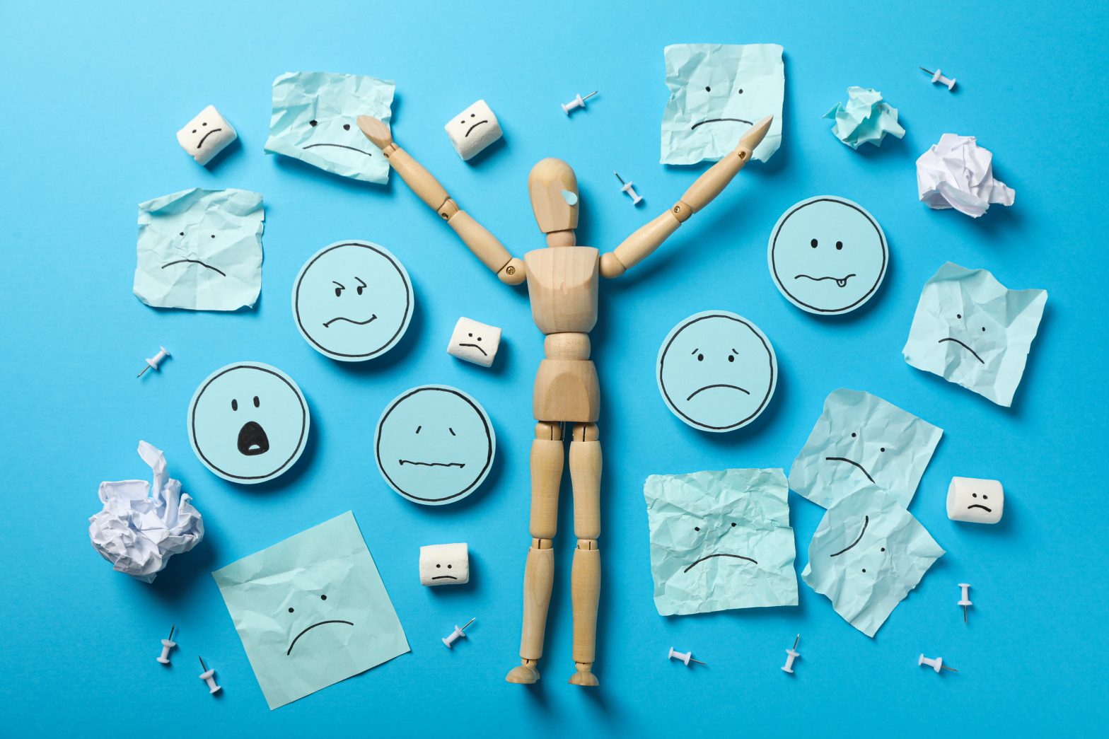 a wooden doll with many faces on it