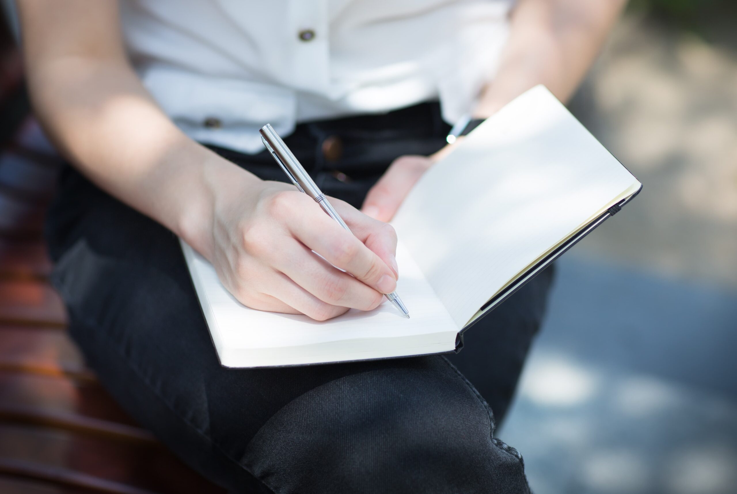 student writing in planner to stay organized and reduce stress