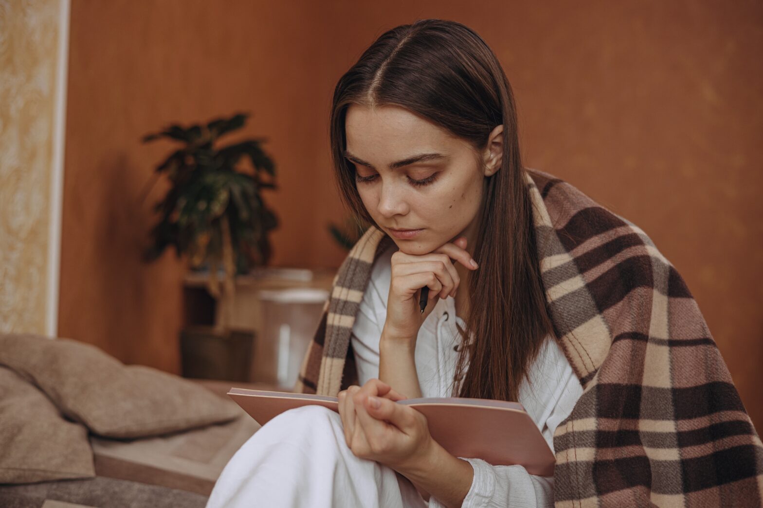 Woman journaling in a peaceful therapy session focused on mental wellness
