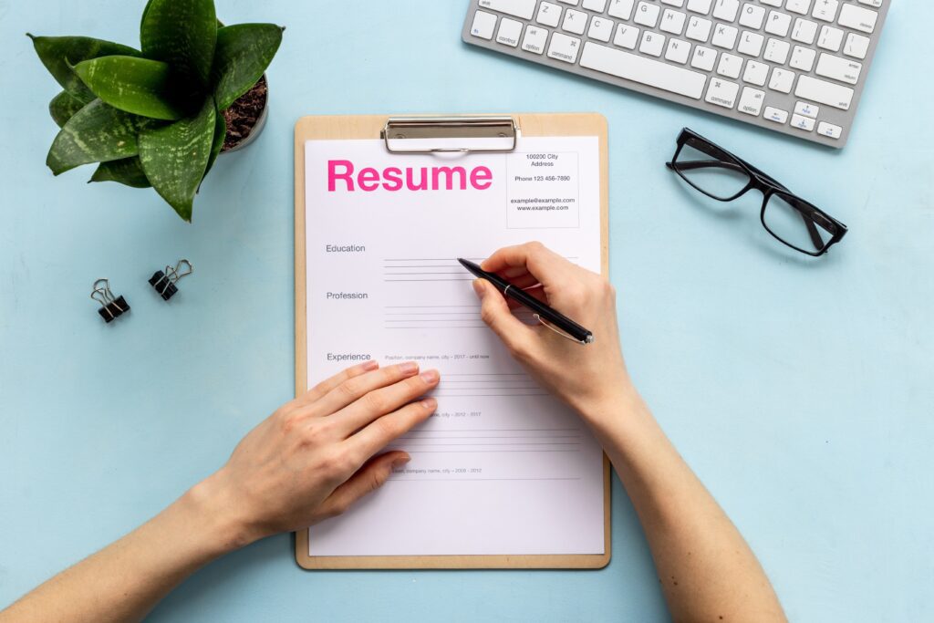 Hand covering personal health information on a resume to maintain privacy.