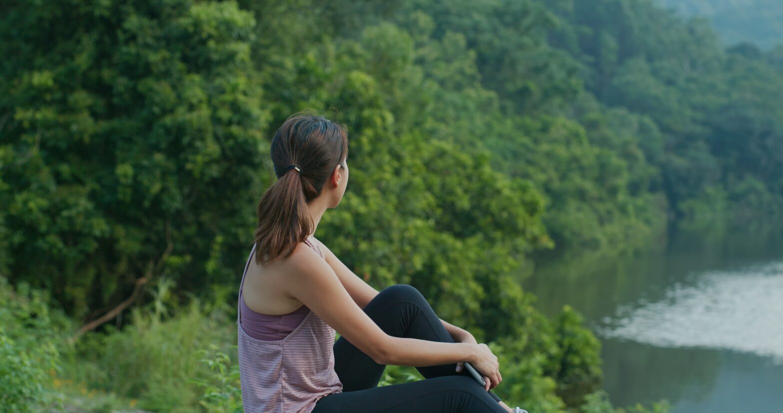 Person standing confidently outdoors showing how recovery can improve self-esteem