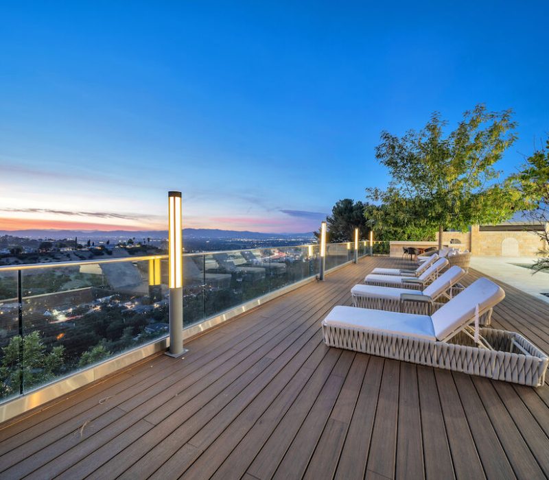 a deck with chairs and a railing