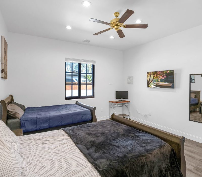 an elegant bedroom with two beds at Vanity Wellness Center's sober living
