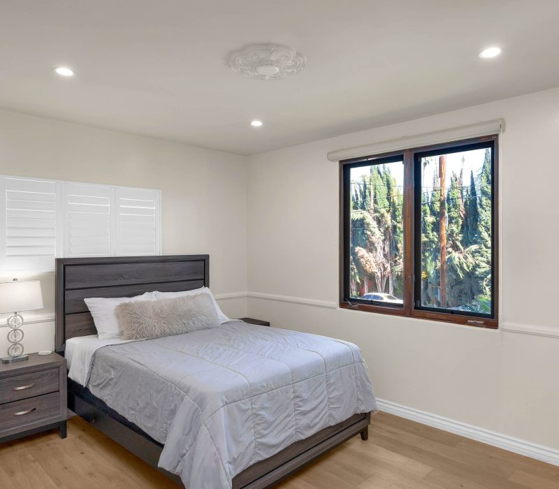 a bedroom with a bed and a window