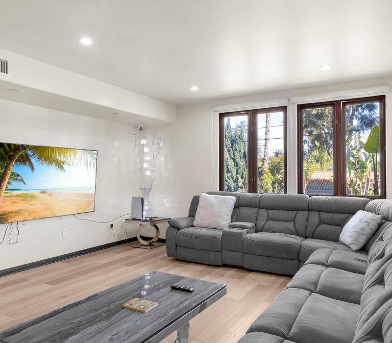 a living room with a large couch and a television