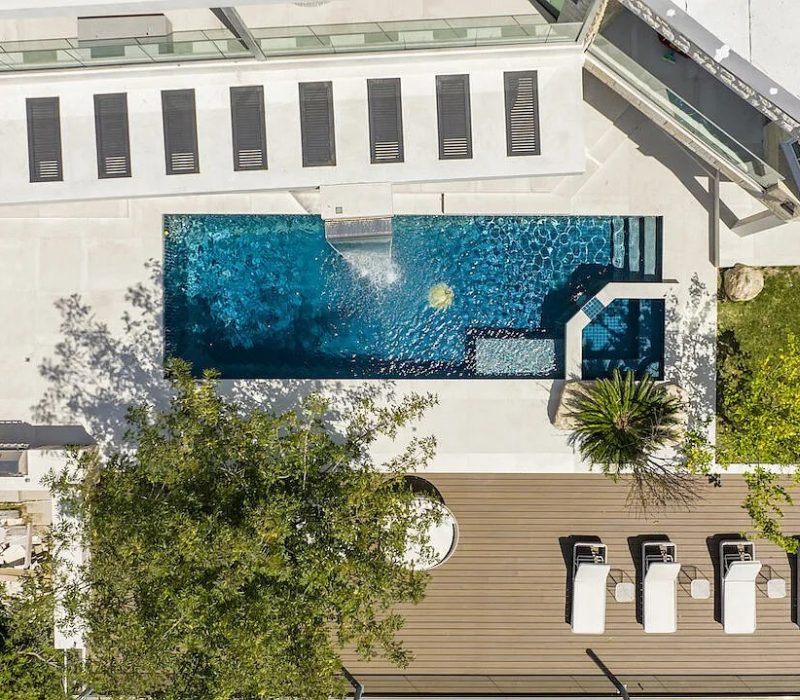 a swimming pool and deck with trees and a deck