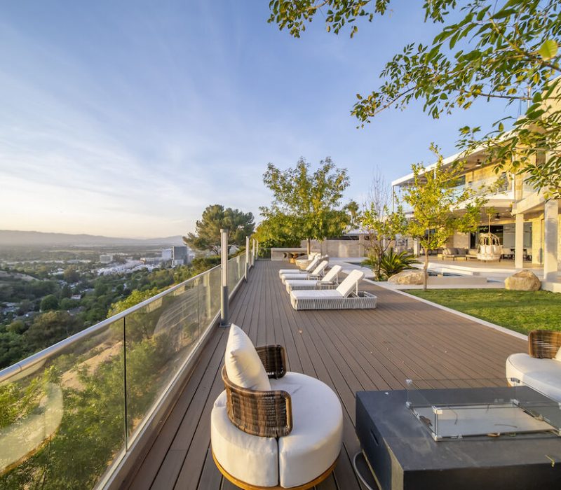 origin a deck with chairs and a fire pit