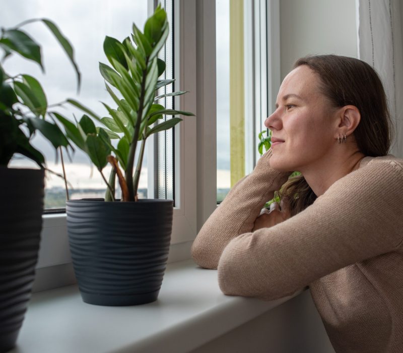 a woman looking out the window during prescription medication drug treatment at Vanity Wellness Center's inpatient detox